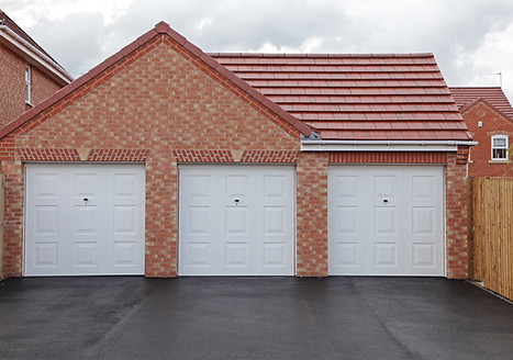 Three new garages in a uk housing development